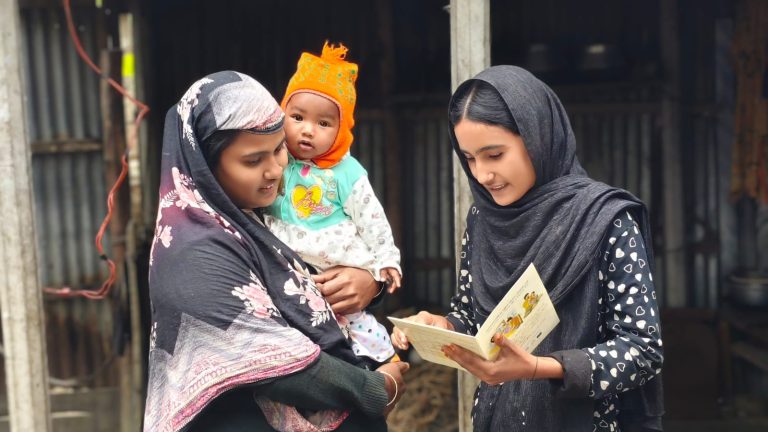 Disha is sharing health-related messages showing a health card to a community member.