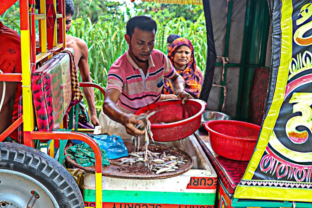 Hanif is selling fish from his mobile fish market.